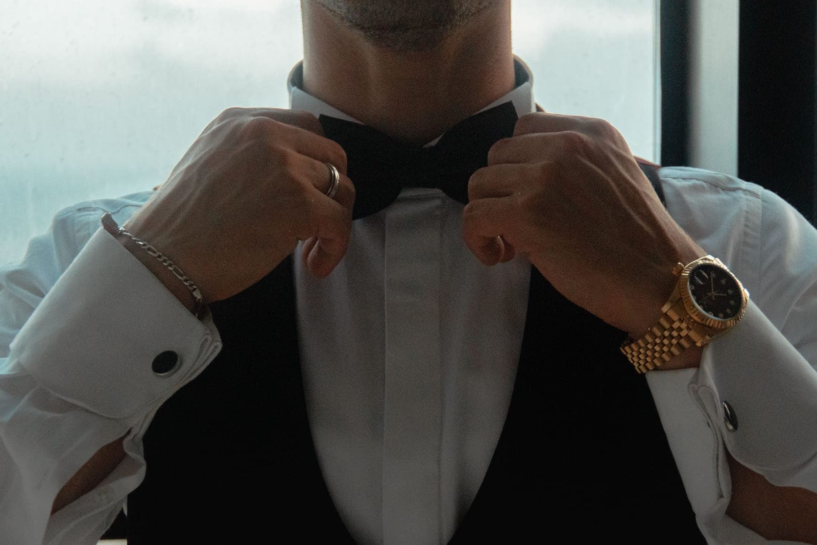 A person fastening a wristwatch onto their wrist