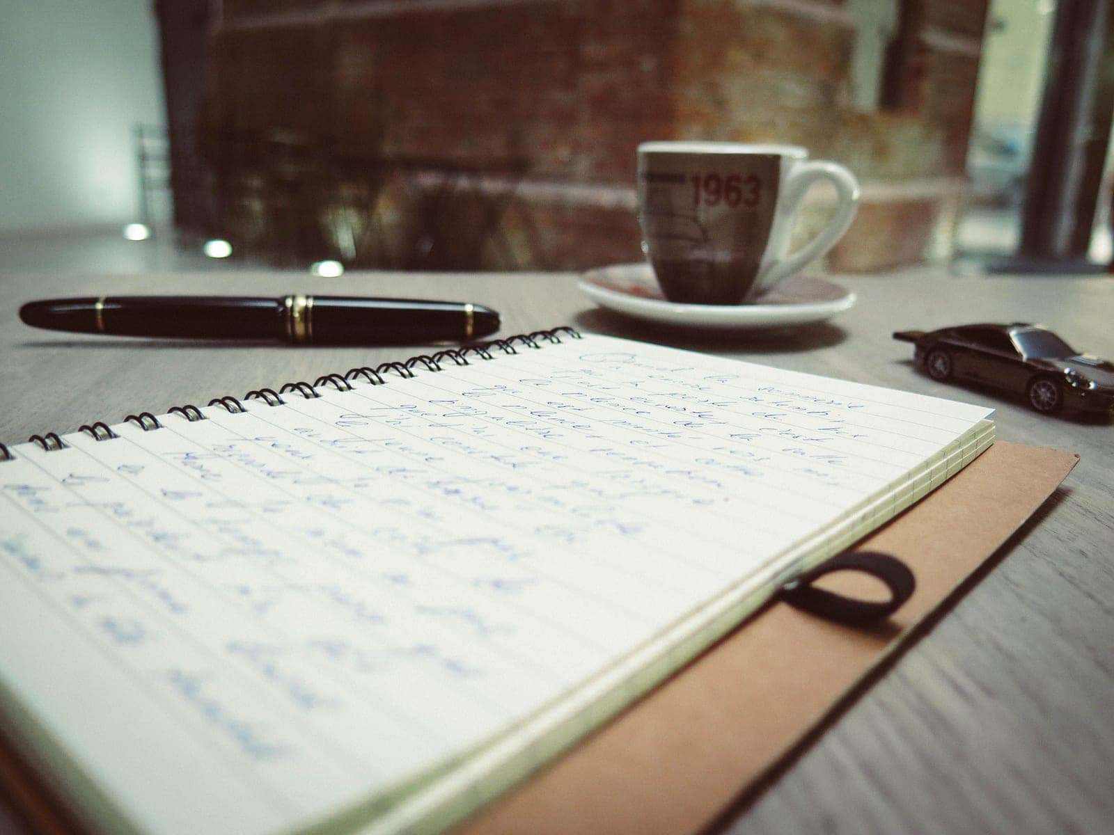A writing desk with notes and a pencil