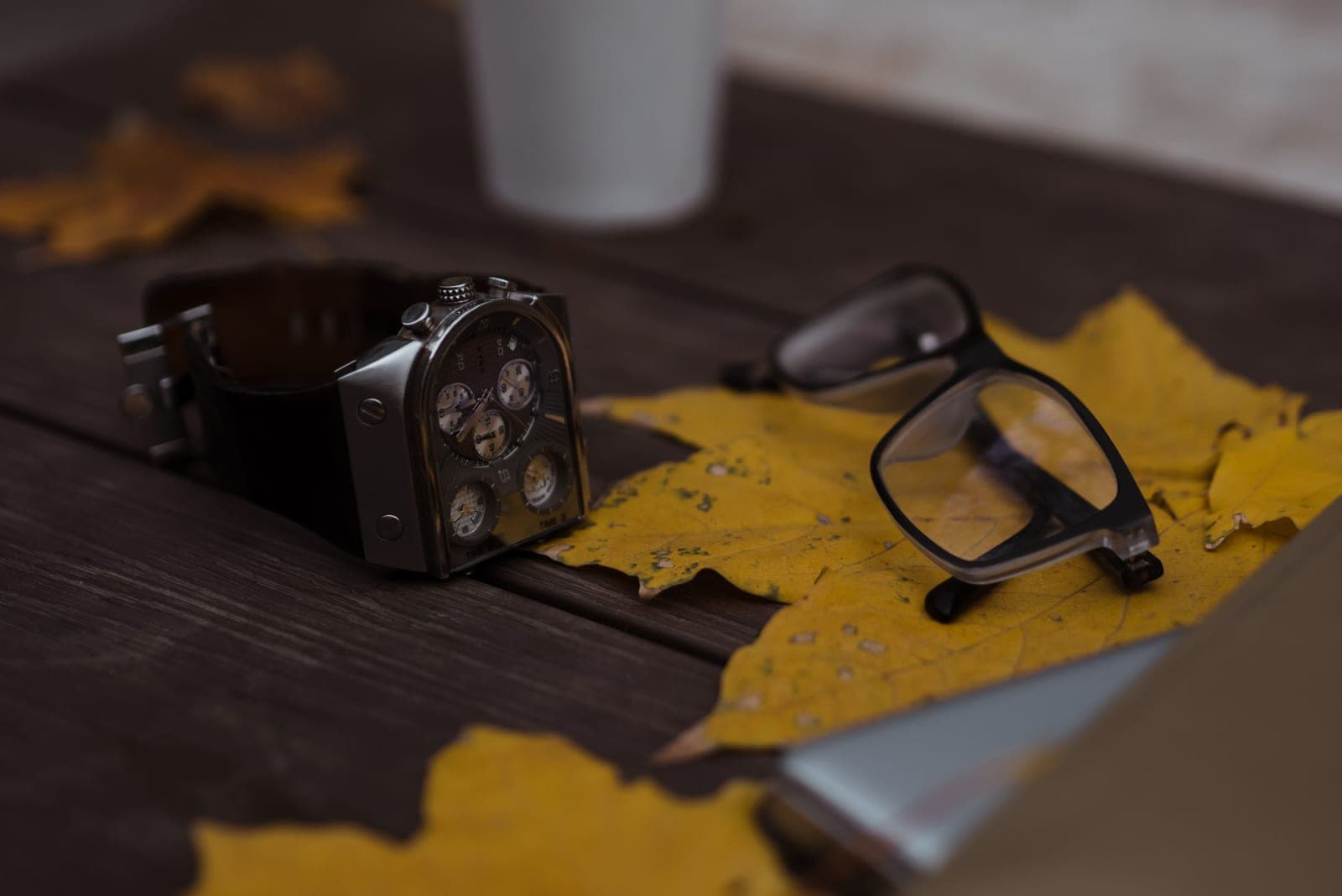 Several wristwatches arranged on a wooden table
