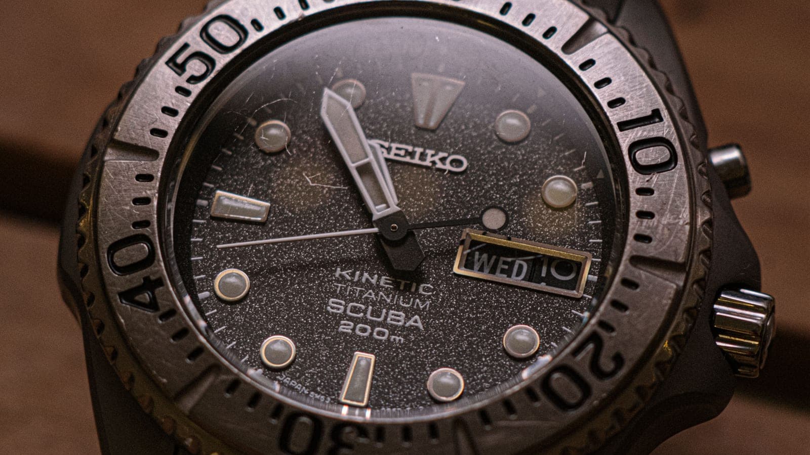 The bezel of a steel dive watch photographed close up