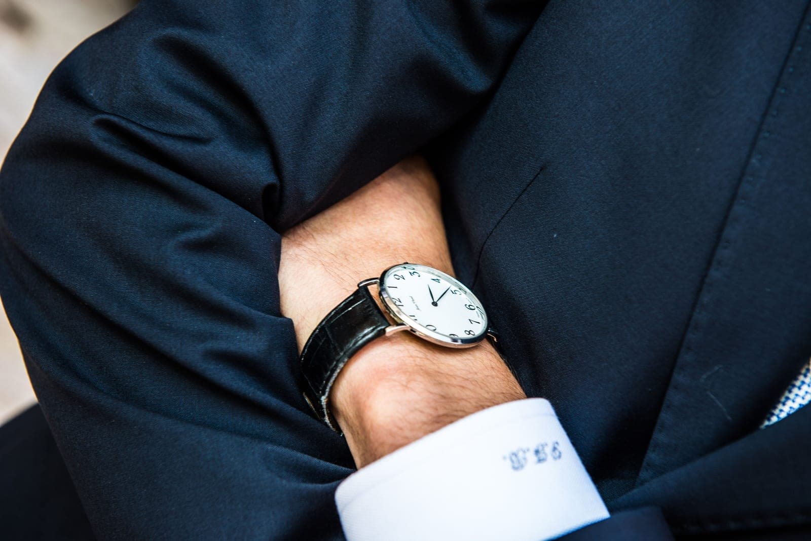 A slim dress watch worn under a shirt cuff