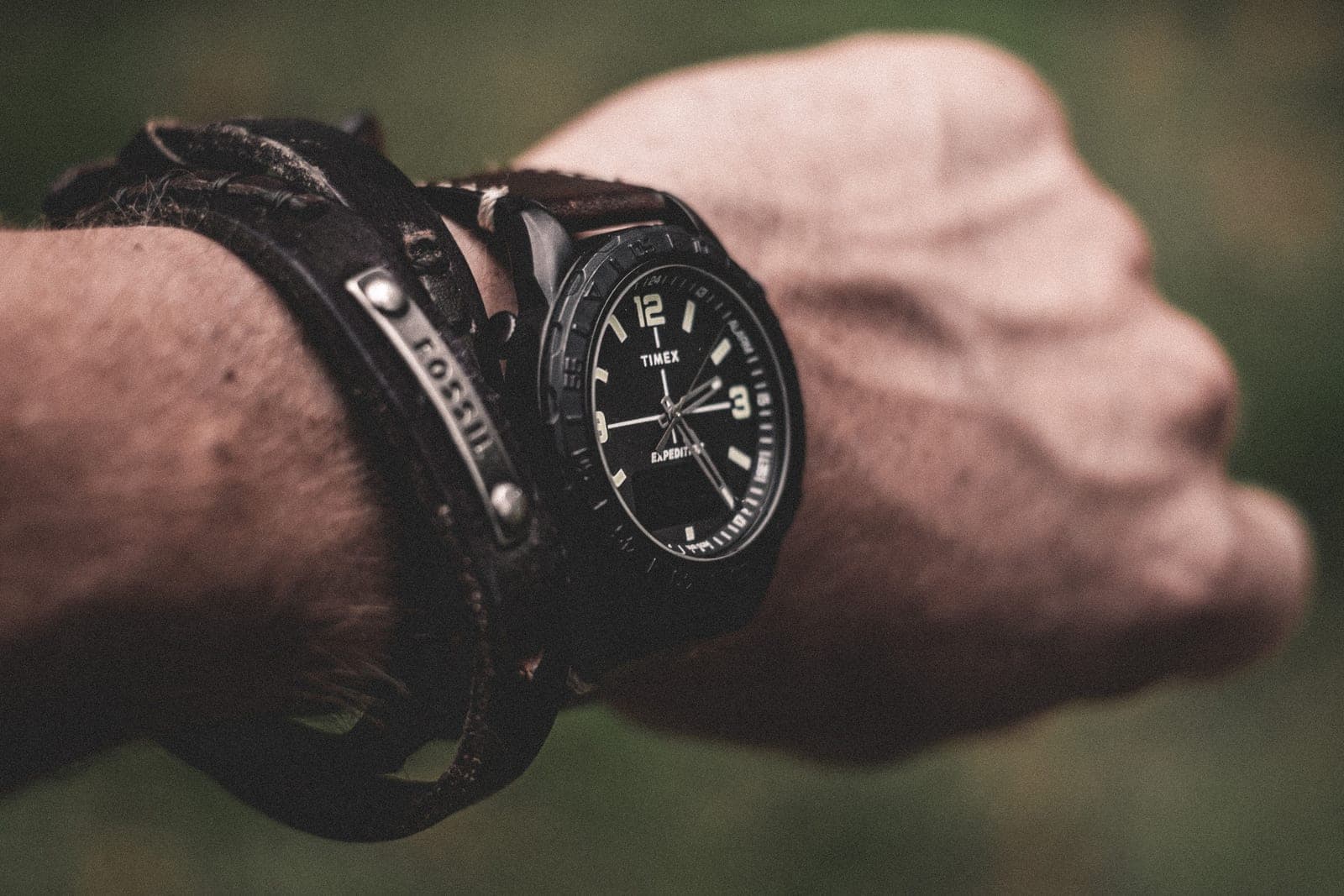 A rugged wristwatch on a leather strap outdoors