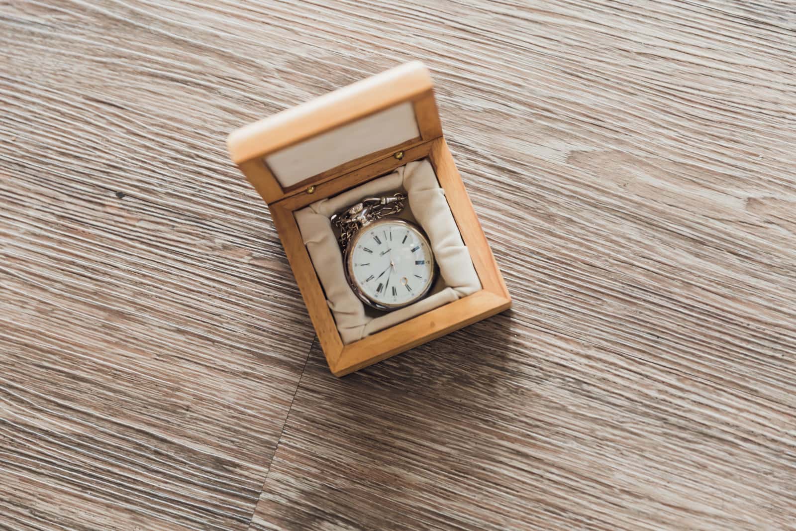 A wooden watch box on a table