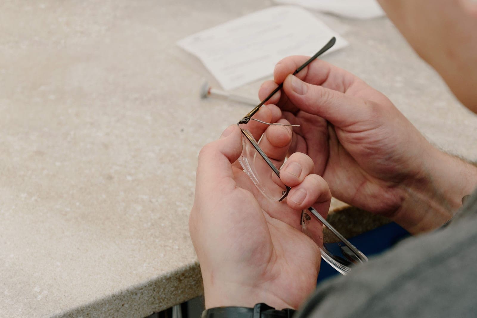 Hands assembling a small precision component