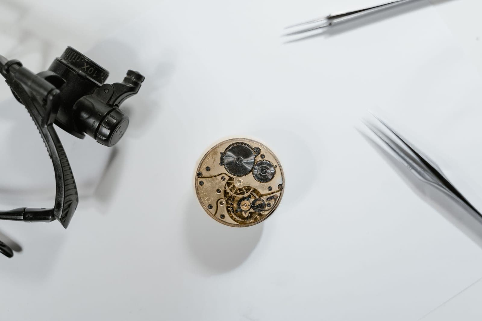 Watch components scattered across a workbench