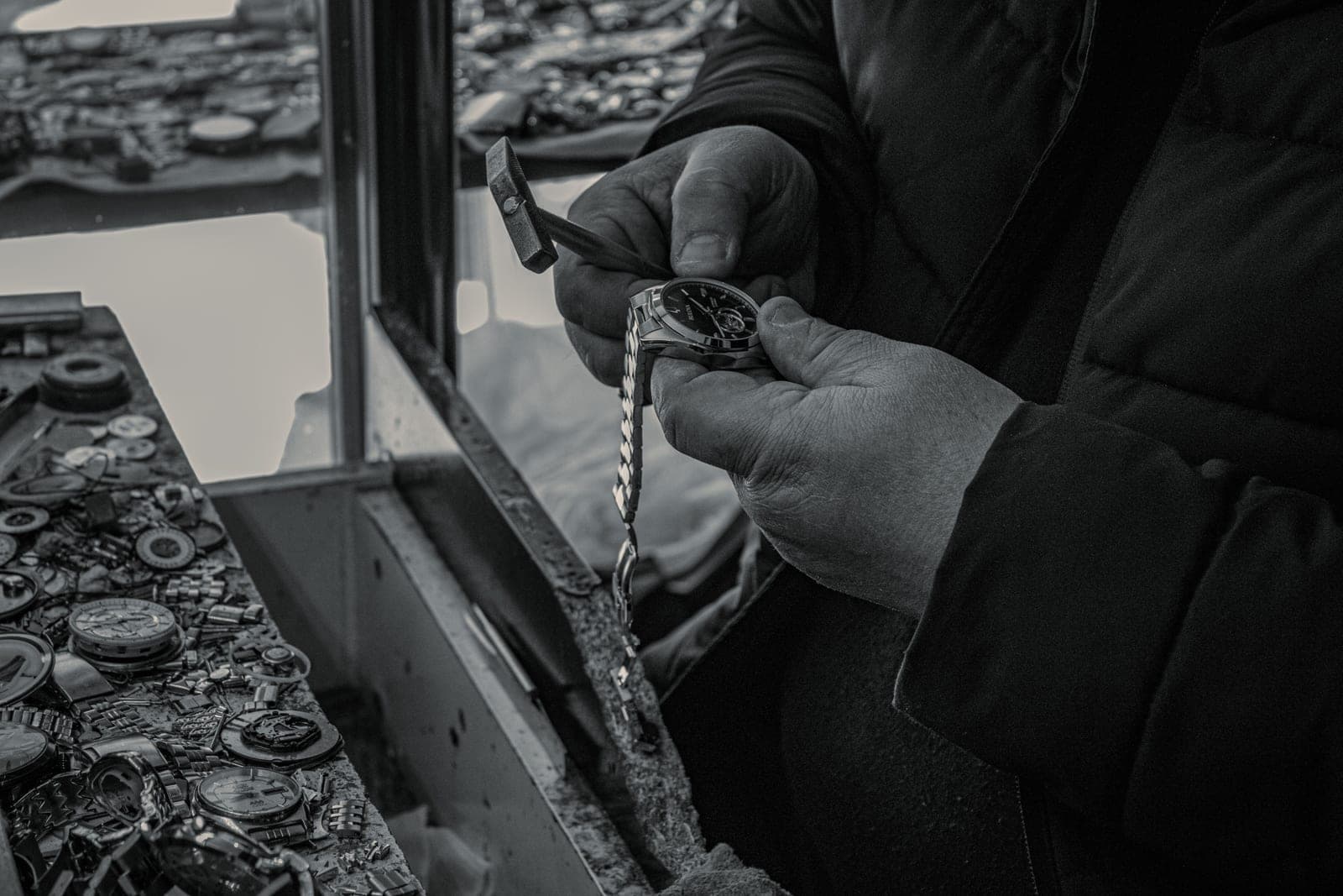 Watch repair tools and tweezers on a bench