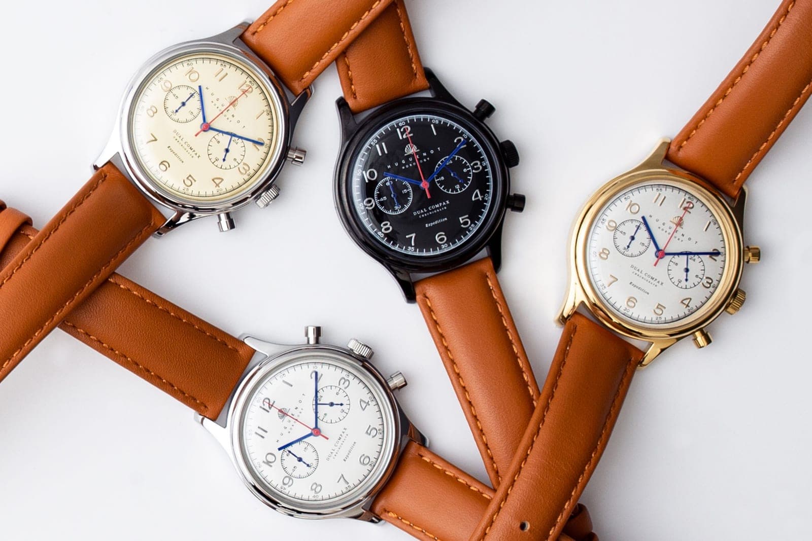 Several wristwatches laid out on a flat surface