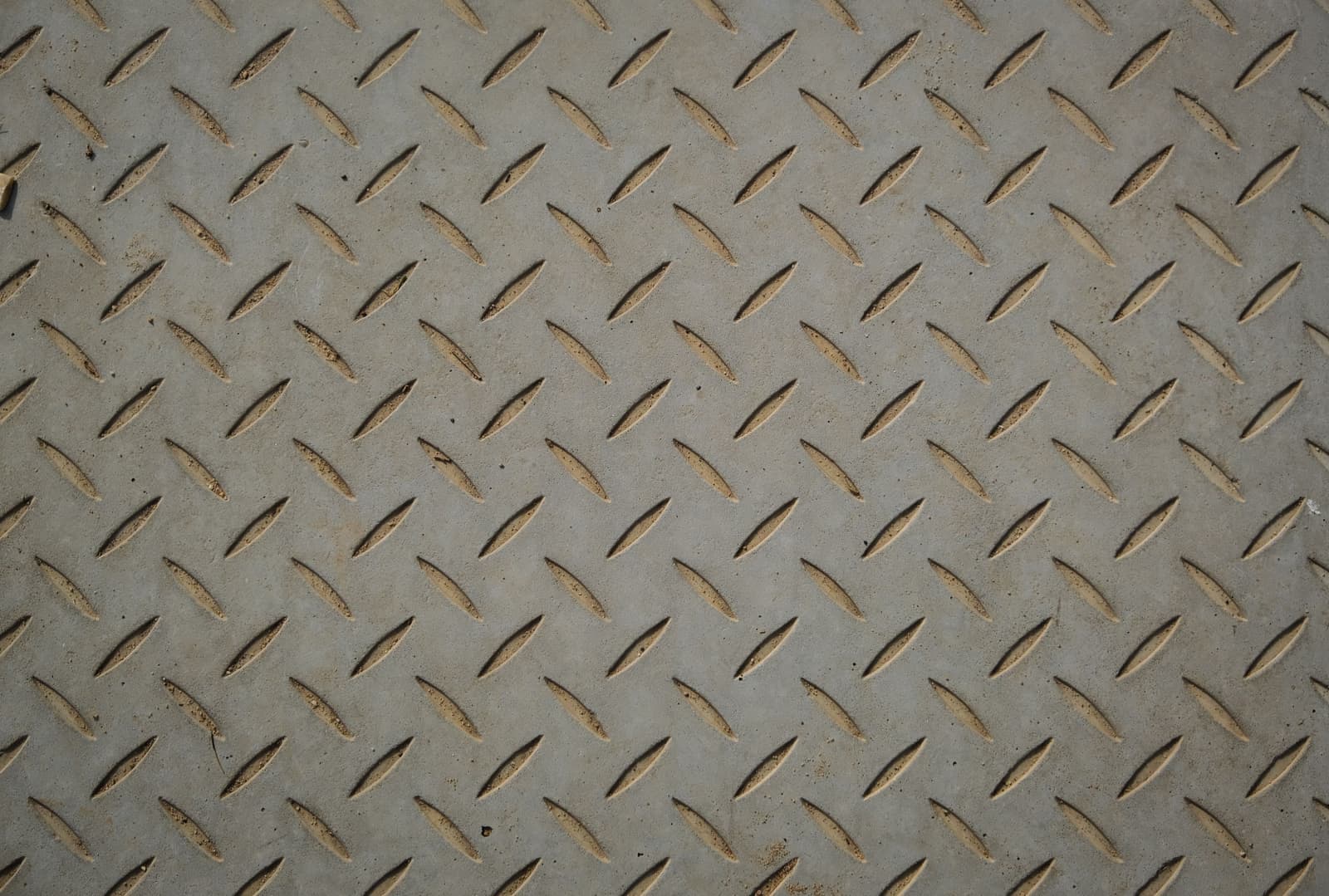 A brushed metal surface with a machined edge