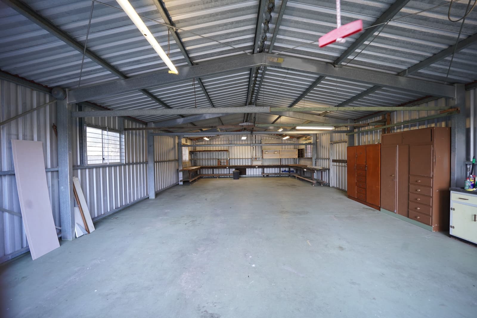 A concrete wall and steel fittings in a workshop